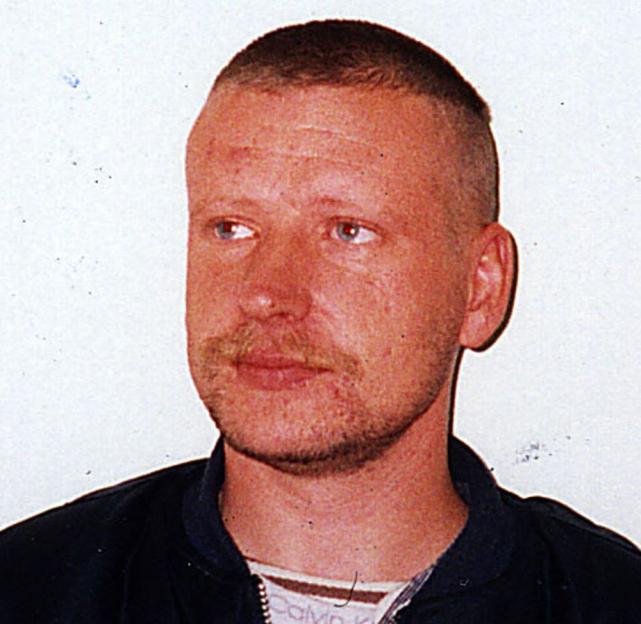Headshot of Darren Vickers, a man with light blue eyes, fair skin, a mustache and beard, and a buzz cut.