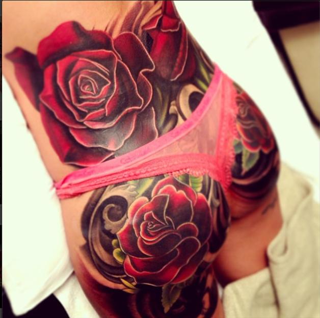 Red rose tattoo on the bottom of Cheryl Cole.