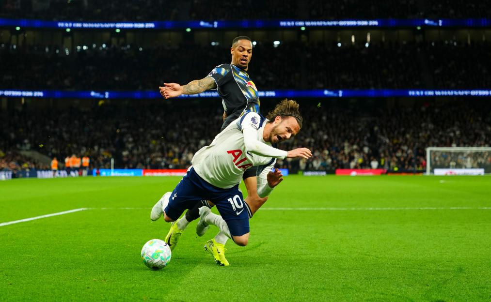 James Maddison of Tottenham Hotspur goes down in the area after a challenge from Lukas Nmecha of Leeds United.