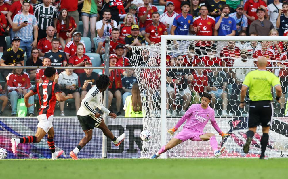 Manchester United's Patrick Dorgu scores their second goal against AC Milan.