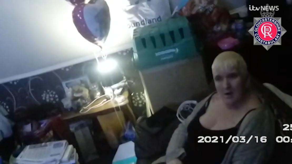 Screenshot from bodycam footage of Amanda Wixon in a cluttered room.
