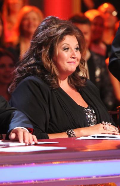 Abby Lee Miller smiling at the judges' table during "Dancing With the Stars."