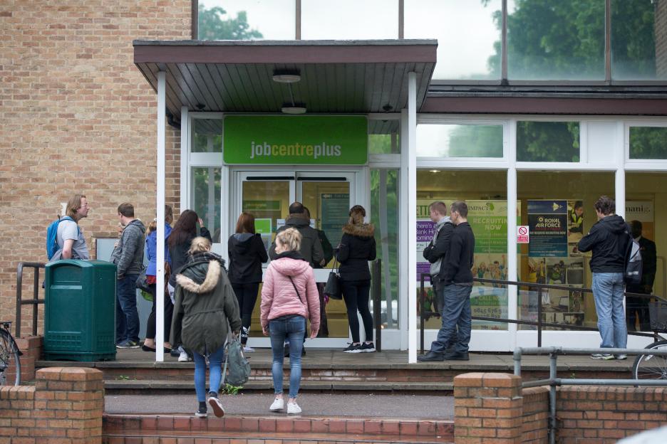 People waiting outside a Job Centre Plus in Cambridge.