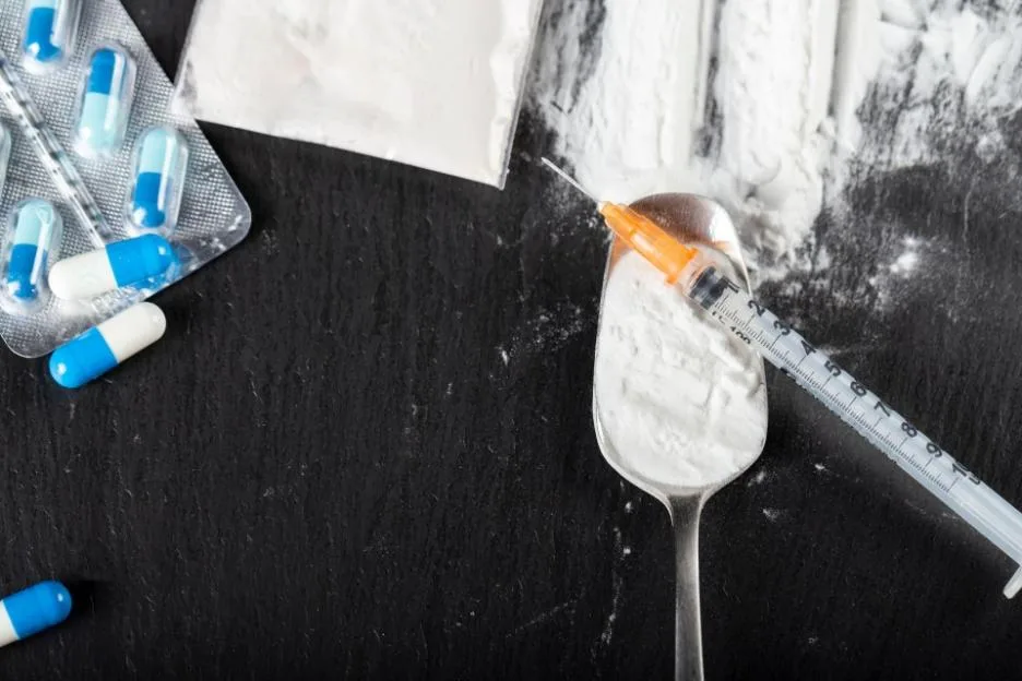 Substance abuse. Hard drugs on dark table