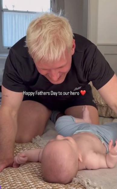 Molly-Mae Hague's Father's Day post for Tommy Fury, showing Tommy kneeling over and smiling at a baby lying on its back.