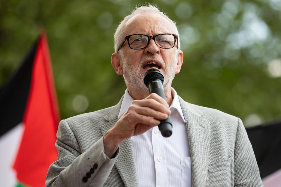 Jeremy Corbyn speaking into a microphone at a pro-Palestinian demonstration.