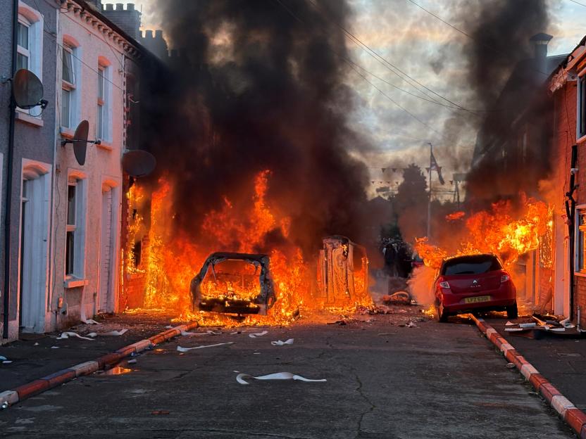 Vehicles set on fire by protesters on Lendrick Street in Belfast.