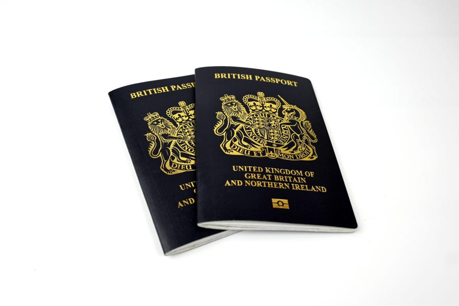 Two British passports on a white background.