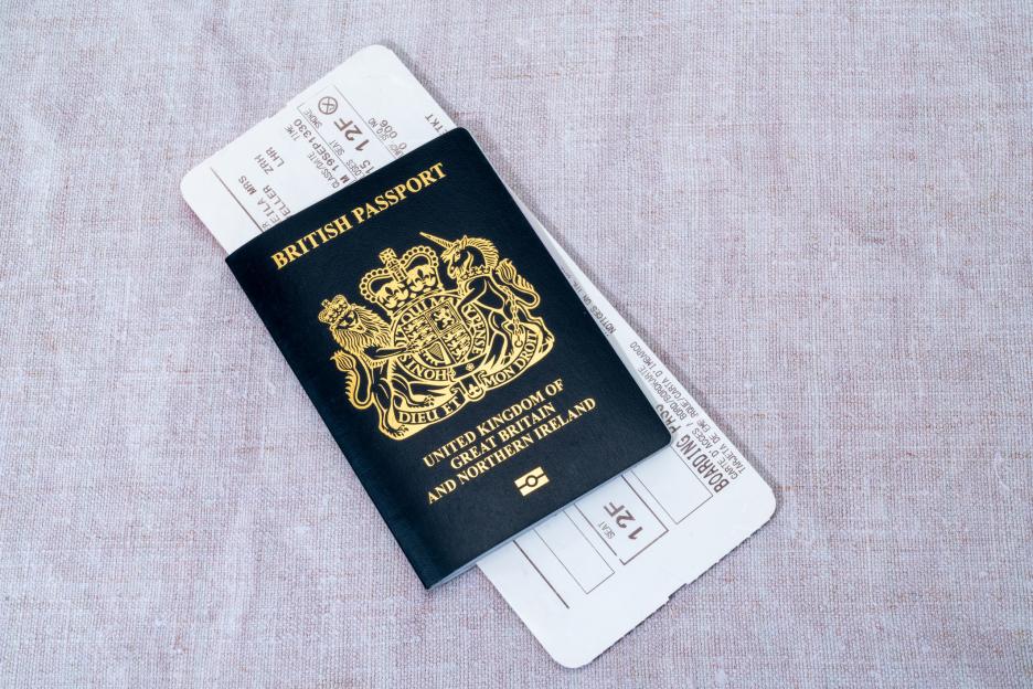 British passport with an airline boarding pass.