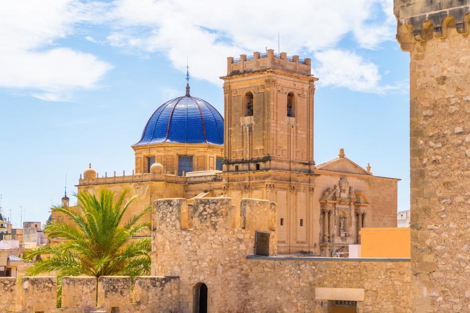 Aerial view of Elche with the Basilica of Santa Maria's blue dome.