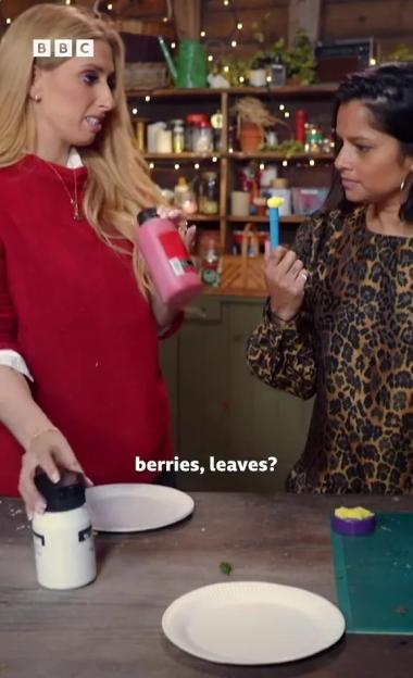 Stacey Solomon and another woman in a crafty setting with paints and paper plates.