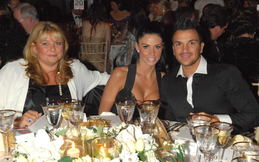 Claire Powell, Katie Price, and Peter Andre seated at a formal event.