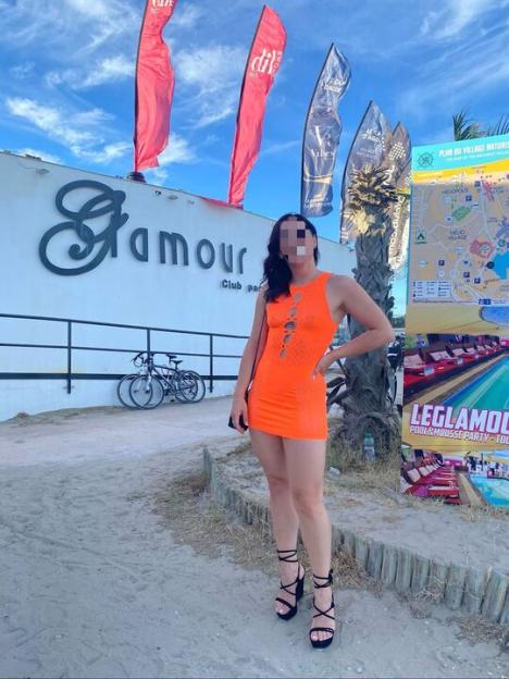 Woman in orange dress at Glam'our club in Cap d'Agde.
