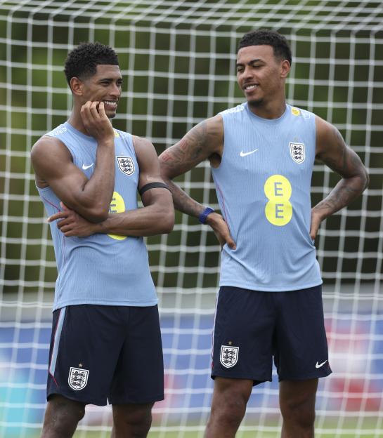 Jude Bellingham and Morgan Rogers of England looking on during a training session.