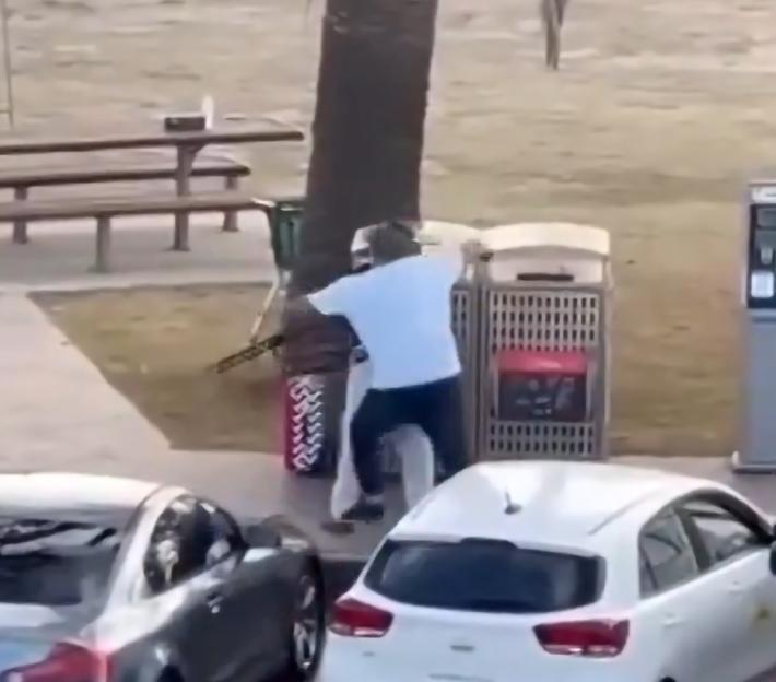 A hero bystander tackling a gunman at Bondi Beach, disarming them.