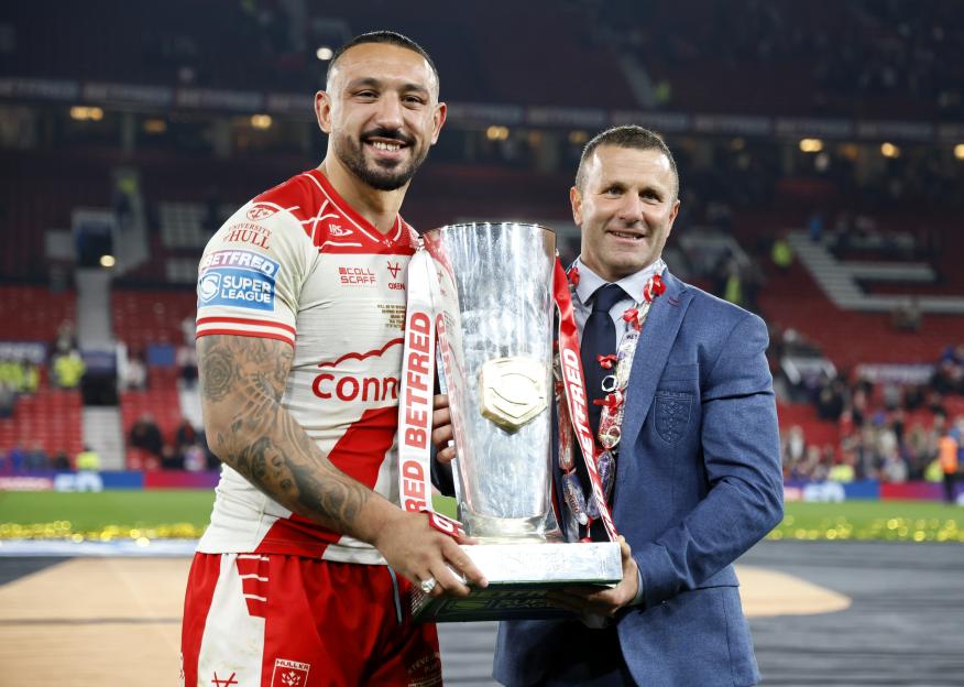 Hull KR's Elliot Minchella and head coach Willie Peters celebrate with the Betfred Super League Grand Final trophy.