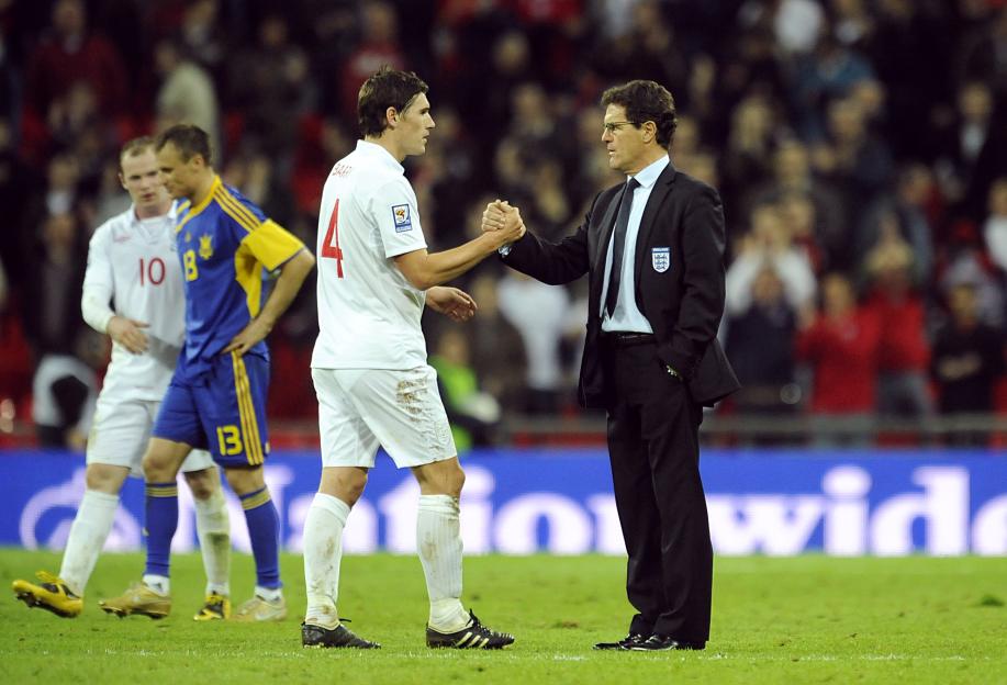 England manager Fabio Capello shaking hands with Gareth Barry after a football match.