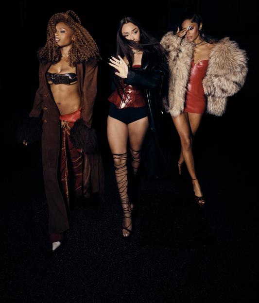 Three women from the girl band Flo in various outfits and poses.