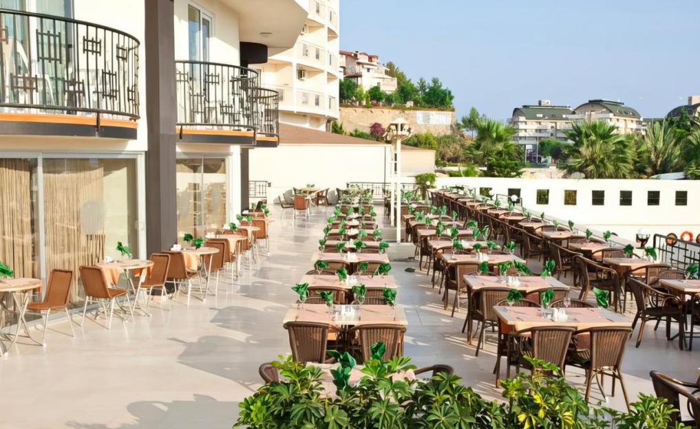 Outdoor dining area with many tables and chairs set up.