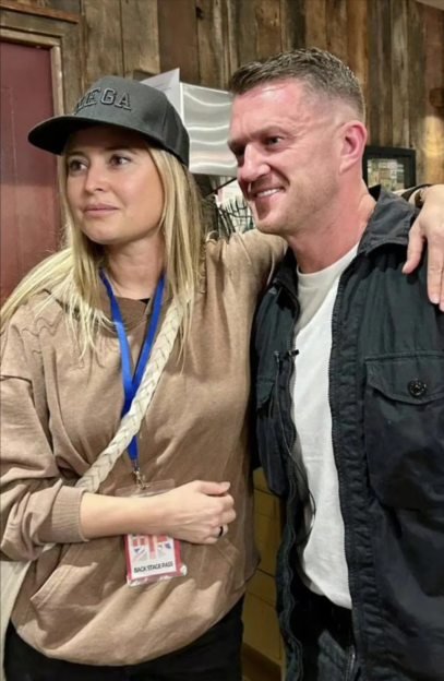 Woman in a "MEGA" cap with a man smiling, both with arms around each other.