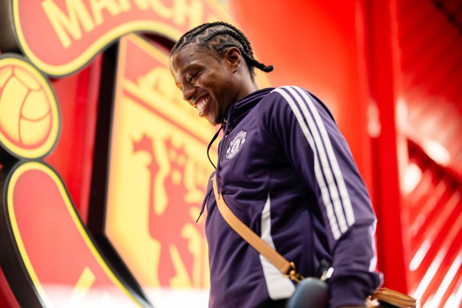 Tyrell Malacia smiling while arriving at the stadium.