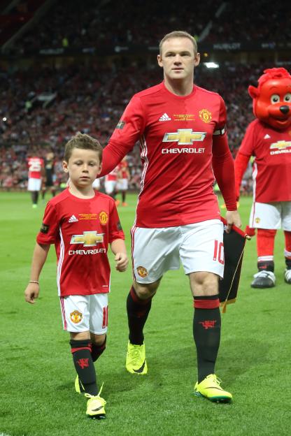 Wayne Rooney and his son Kai Rooney on the field during the Wayne Rooney Testimonial match.