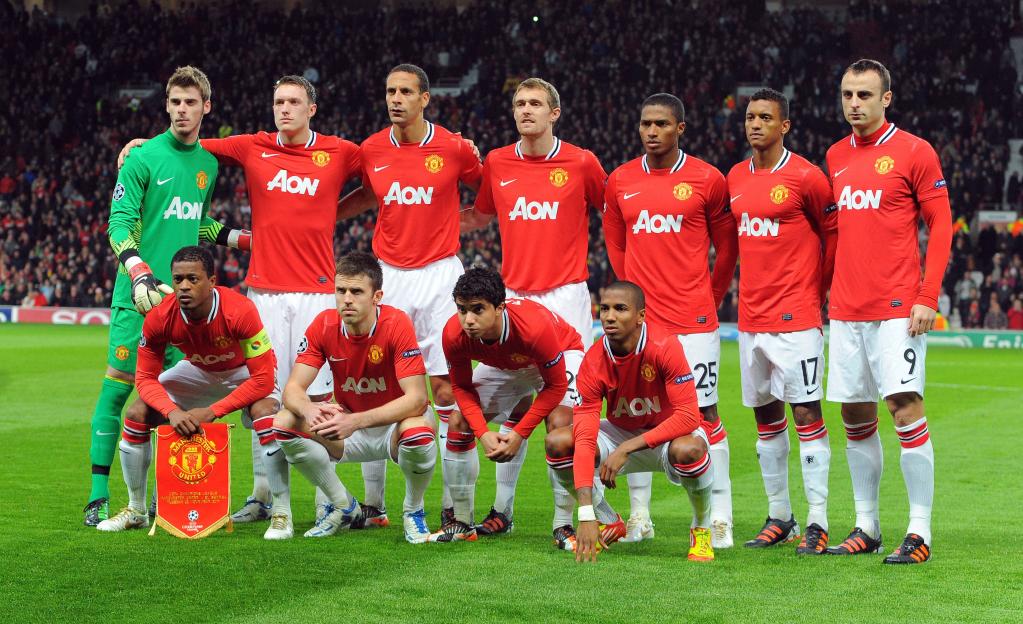 Manchester United football team lines up on the field before a match.