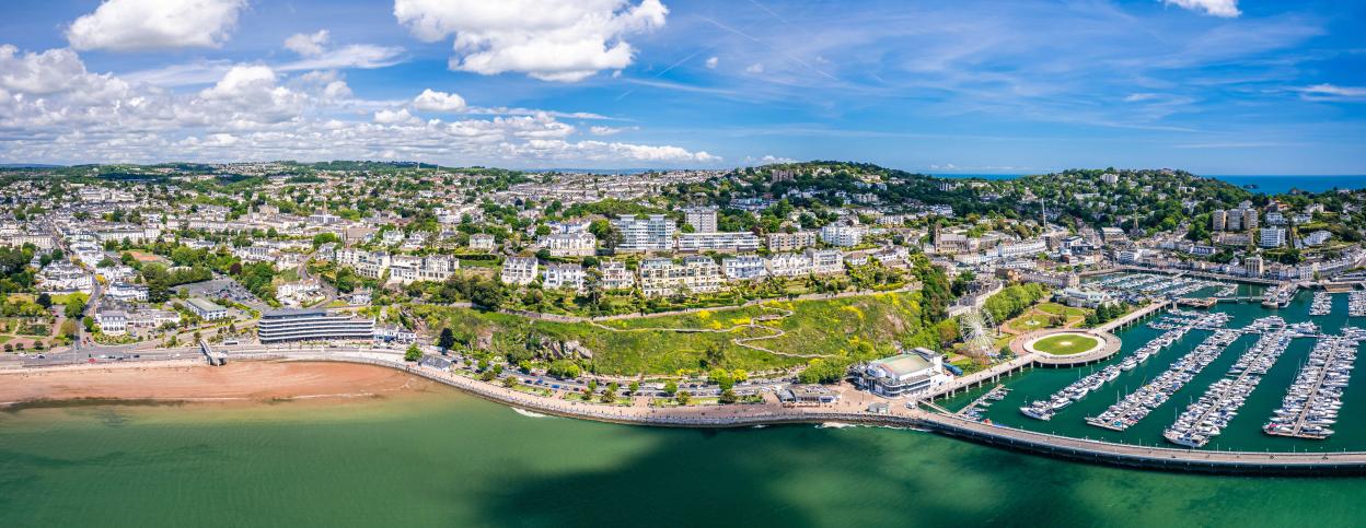 Panorama of the English Riviera, Torquay, Devon, England, Europe, from a drone, showing the coastal town, beach, and marina.