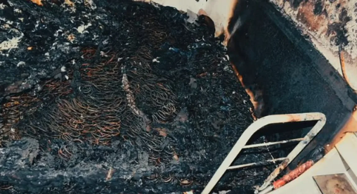 Burned bed frame and mattress showing exposed springs.