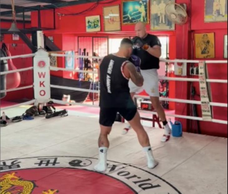 Two men sparring in a boxing ring.
