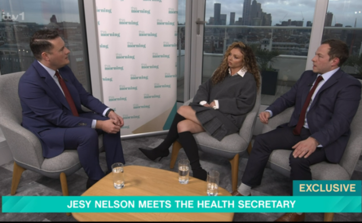 Jesy Nelson speaking with the Health Secretary and another man in a "This Morning" interview.