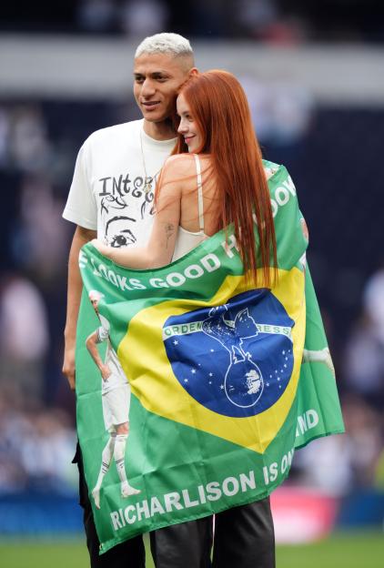 Richarlison and Amanda Araujo with a Brazilian flag over her shoulders after the Tottenham Hotspur v Burnley match.
