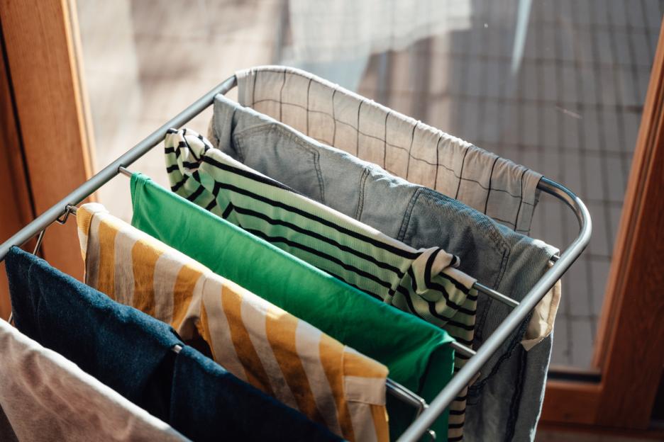 Clean laundry hanging on a drying rack.