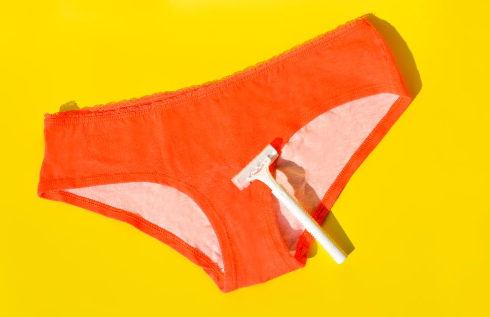 Orange underwear with a white razor on a yellow background.