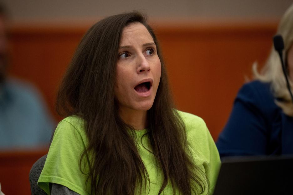 Kouri Richins, wearing a bright green shirt, has a shocked expression with her mouth open and eyes wide, looking upward and to her right.