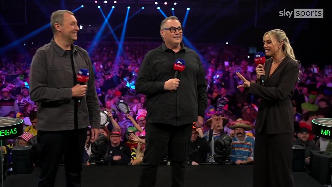 Emma Paton and two male presenters interviewing people at a darts match.