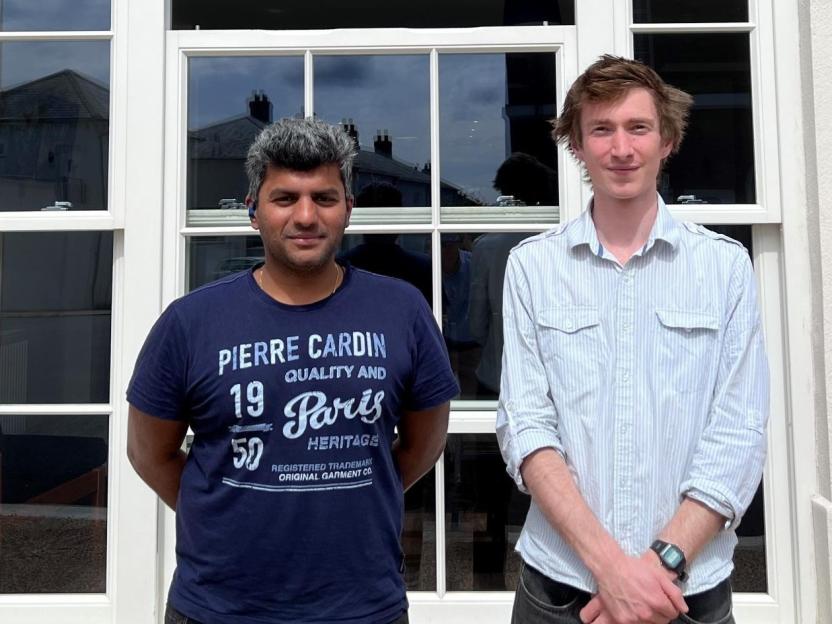 Crossroads Cafe owners Sahil Dalvi and Matt McCourtie posing for a photo.