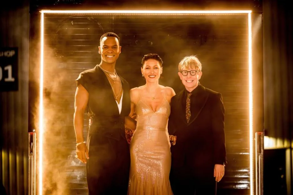 Johannes Radebe, Emma Willis, and Josh Widdicombe smiling and posing for a photo.