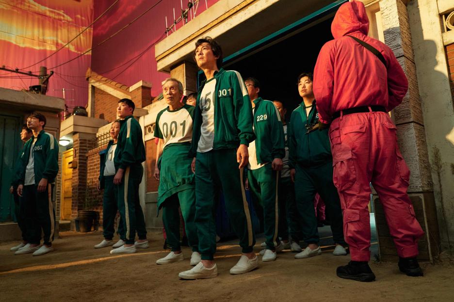 Squid Game contestants in green tracksuits.