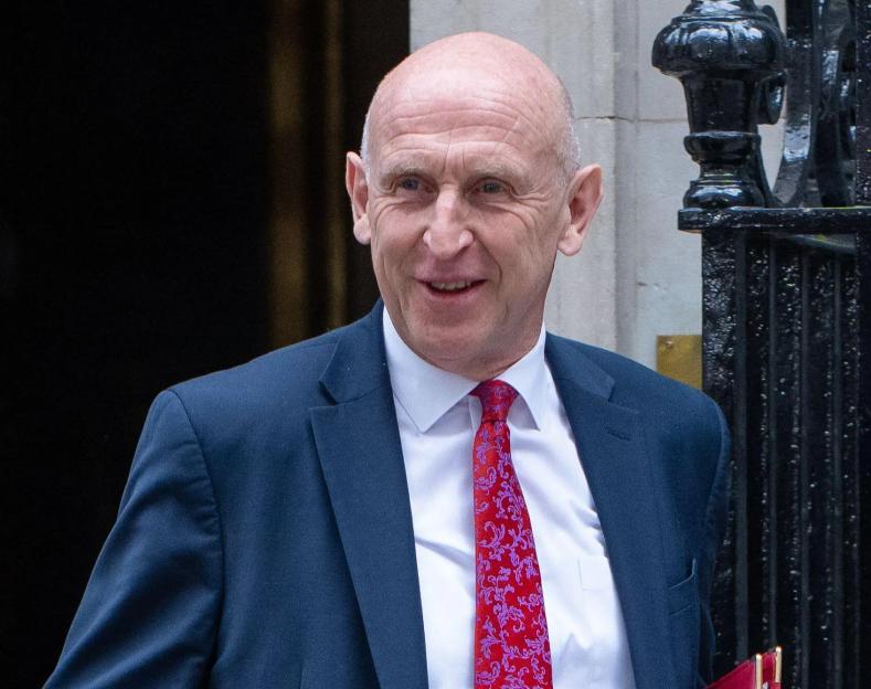John Healey, Britain's Chancellor of the Exchequer, smiles while leaving 10 Downing Street.