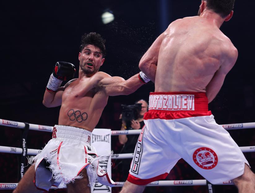 Josh Kelly throws a punch at Bakhram Murtazaliev during their IBF World Super Welterweight Title fight.