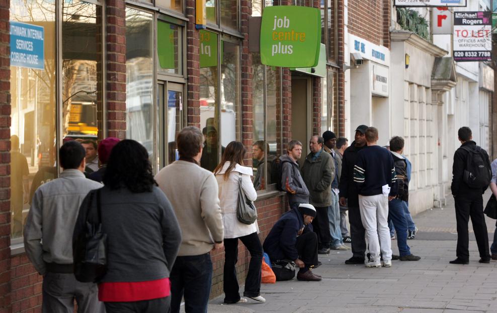 A queue of people outside a "job centre plus" building.