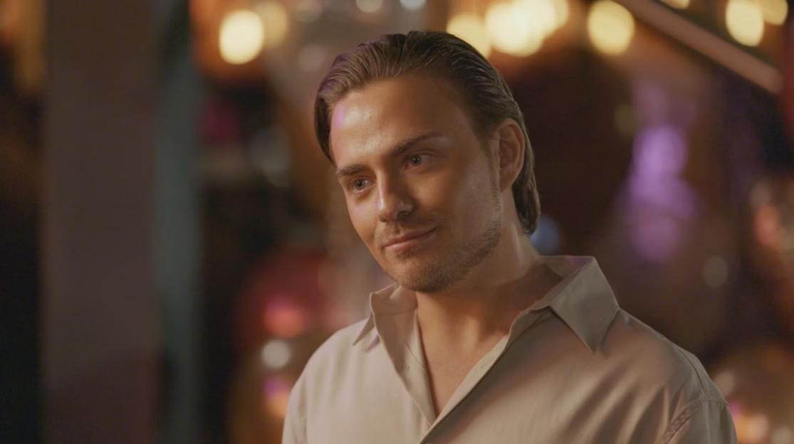 Freddie Bentley, star of The Only Way Is Essex, looking down and to the right while smiling faintly.