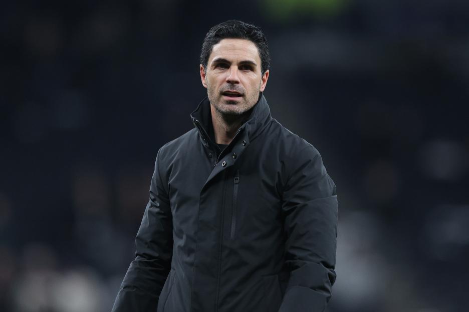 Arsenal head coach Mikel Arteta in a black jacket, celebrating during a Premier League match.