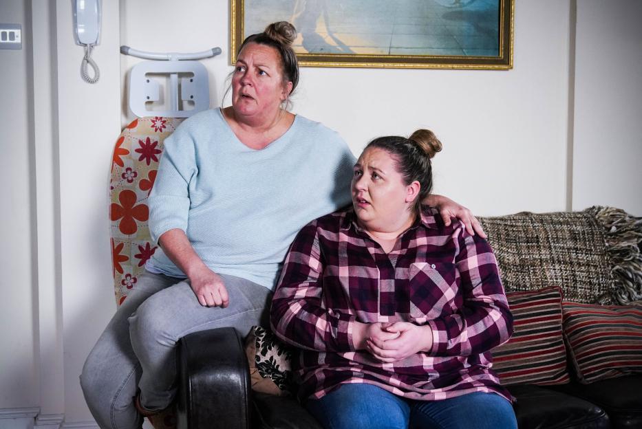Karen Taylor and Bernadette Taylor sitting on a couch.