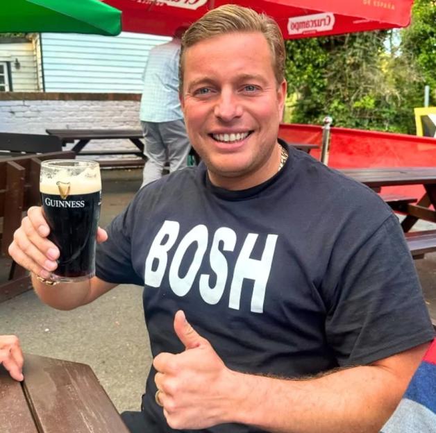 Thomas Skinner, founder of Bosh Beds, smiling and holding a pint of Guinness while giving a thumbs up.