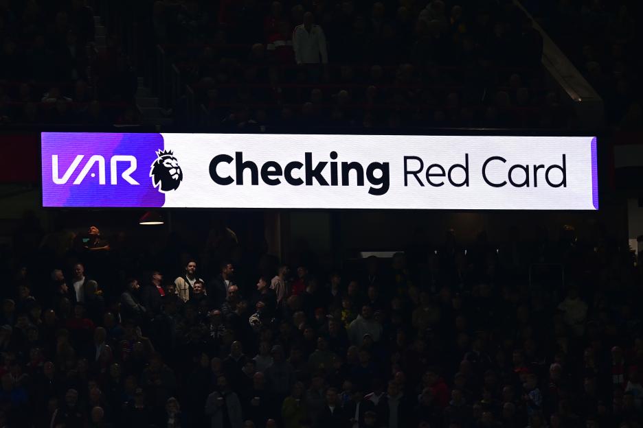 Scoreboard showing "VAR Checking Red Card" during a Premier League match.