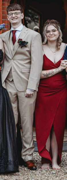 Ryan Pepper and a woman posing together, with the woman holding his arm.