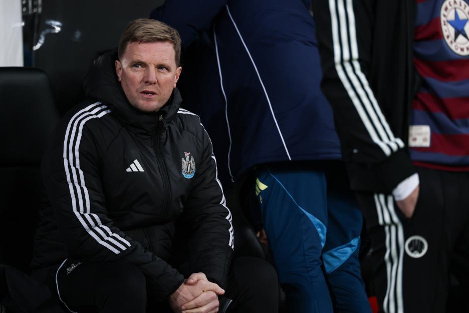 Newcastle United Head Coach Eddie Howe sitting on the bench during a soccer match.