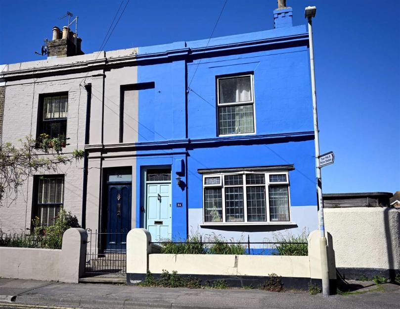 Pensioner ordered to repaint lovely blue home after one neighbour complains